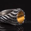 This silver man's ring is made of a silky tiger eye stone with a smooth texture and a honey-like sheen.