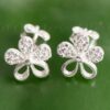 A gleaming pair of petite floral shaped silver earrings.