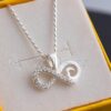 A charming infinity pendant necklace lined with shimmering cz stones & embellished with a silver accented heart symbol.