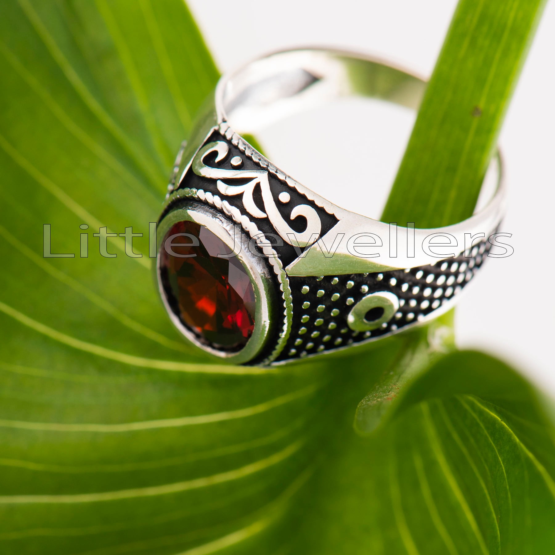 Show off your individuality with this handcrafted high polished sterling silver mens ring with art etched into the side of the band and a red stone on top.