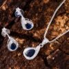 This delicate pear-shaped silver necklace has a blue zirconia stone