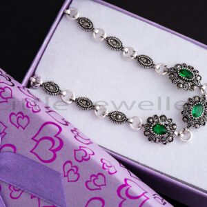 This alluring emerald green silver bracelet set with captivating marcasite stones is sure to charm you.