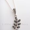 Symbolize peace and friendship with the beautiful Olive Leaf Pendant necklace. Crafted from sterling silver and glistening marcasite stones