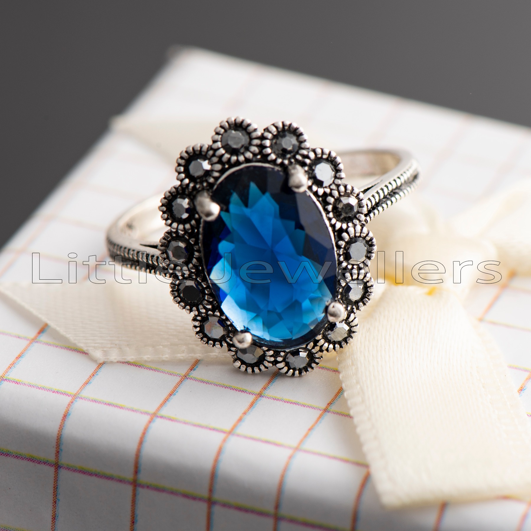 Make your outfit stand out with a touch of sophistication by wearing this beautiful silver ring adorned with a striking blue sapphire cz stone. Whether you're dressed up in sun dresses or traditional Kitenge attire