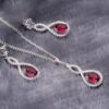 Make her smile with this beautiful sterling silver necklace and earrings set featuring a stunning red gem. The unique design catches the eye and will be sure to turn heads every time she wears it.