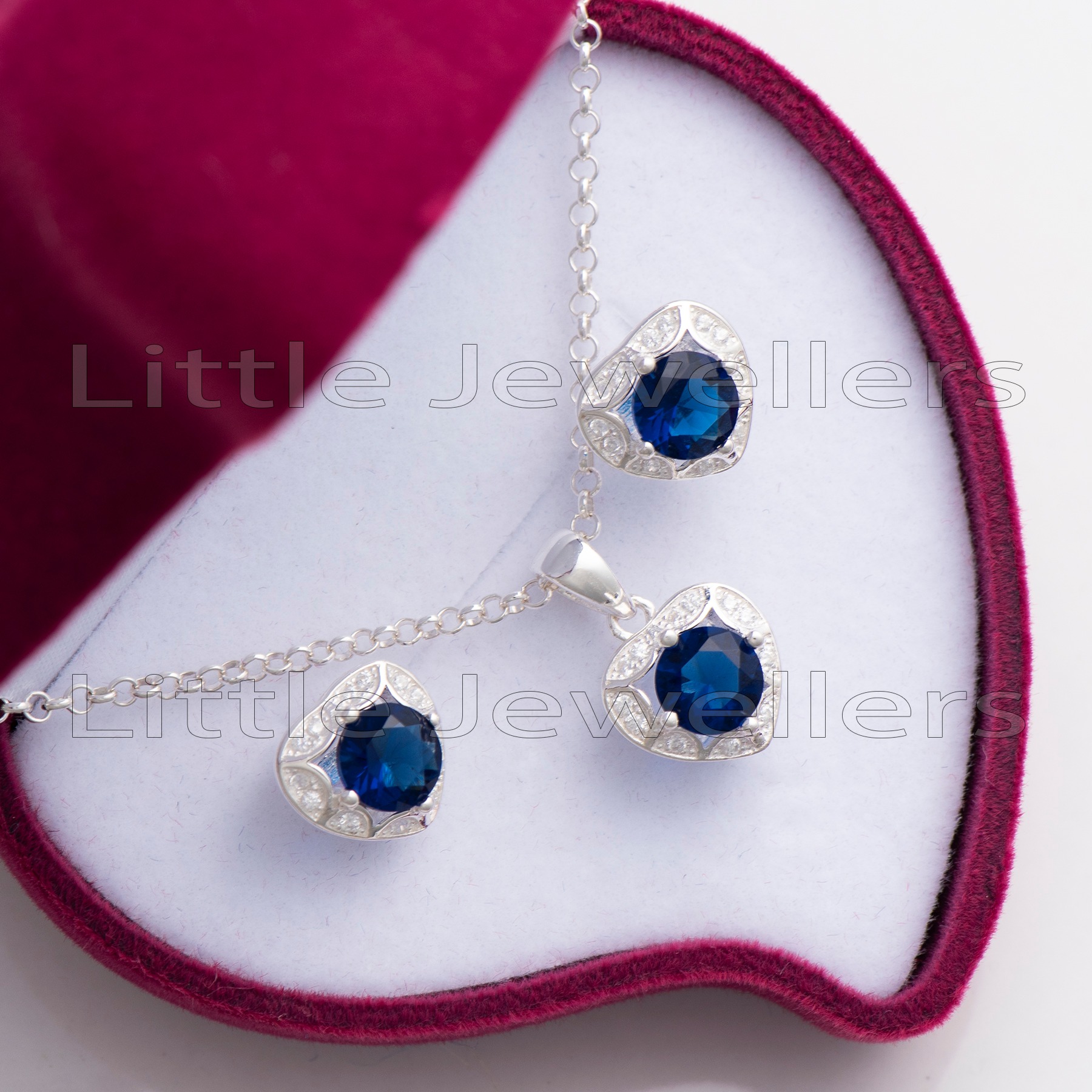 Capture their heart with this exquisite blue heart shaped necklace set in silver. It comes complete with a matching pair of stud earrings that will make the perfect gift for any occasion.