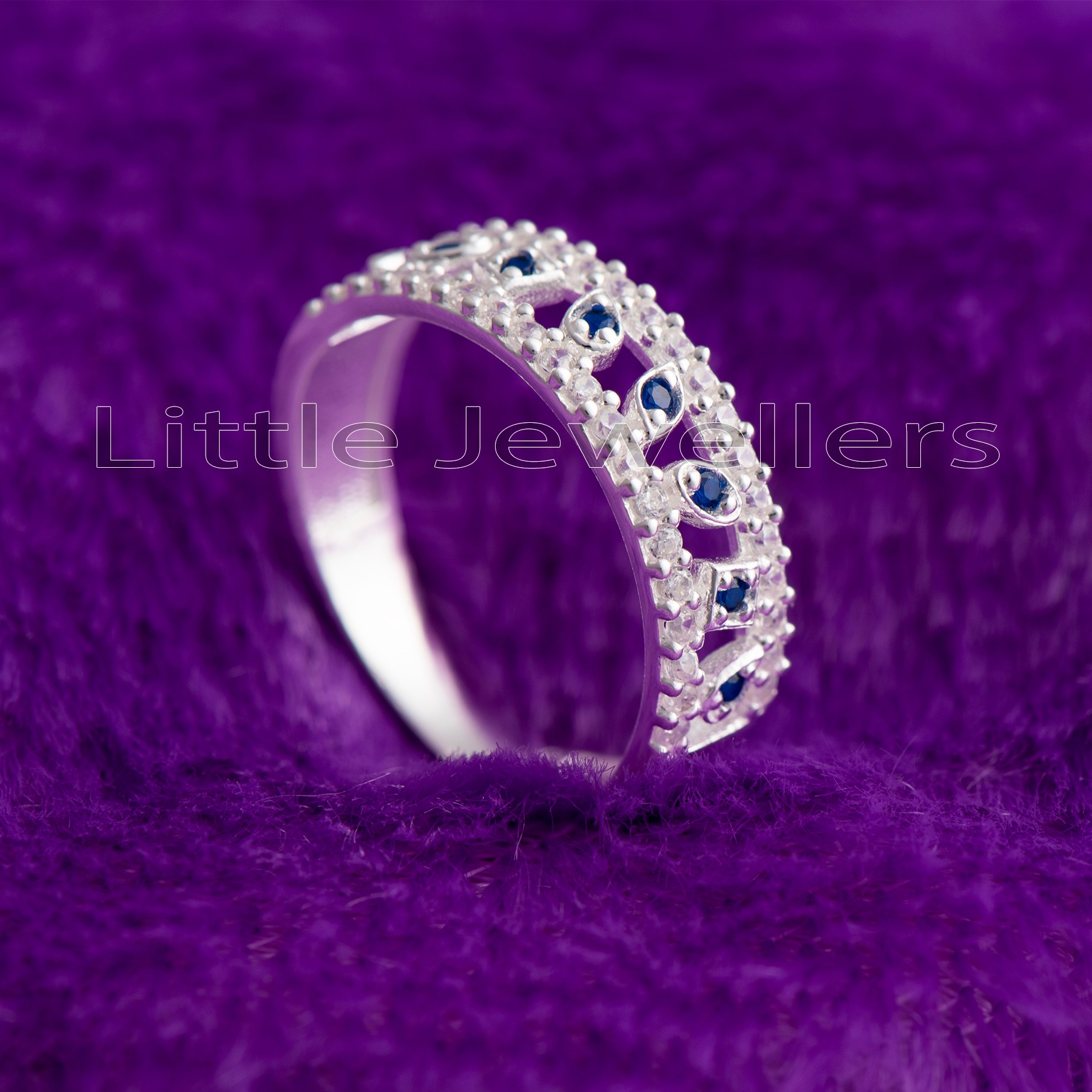 Give her the perfect anniversary gift with this beautiful half eternity ring. Crafted from sterling silver and sparkling sapphire gems