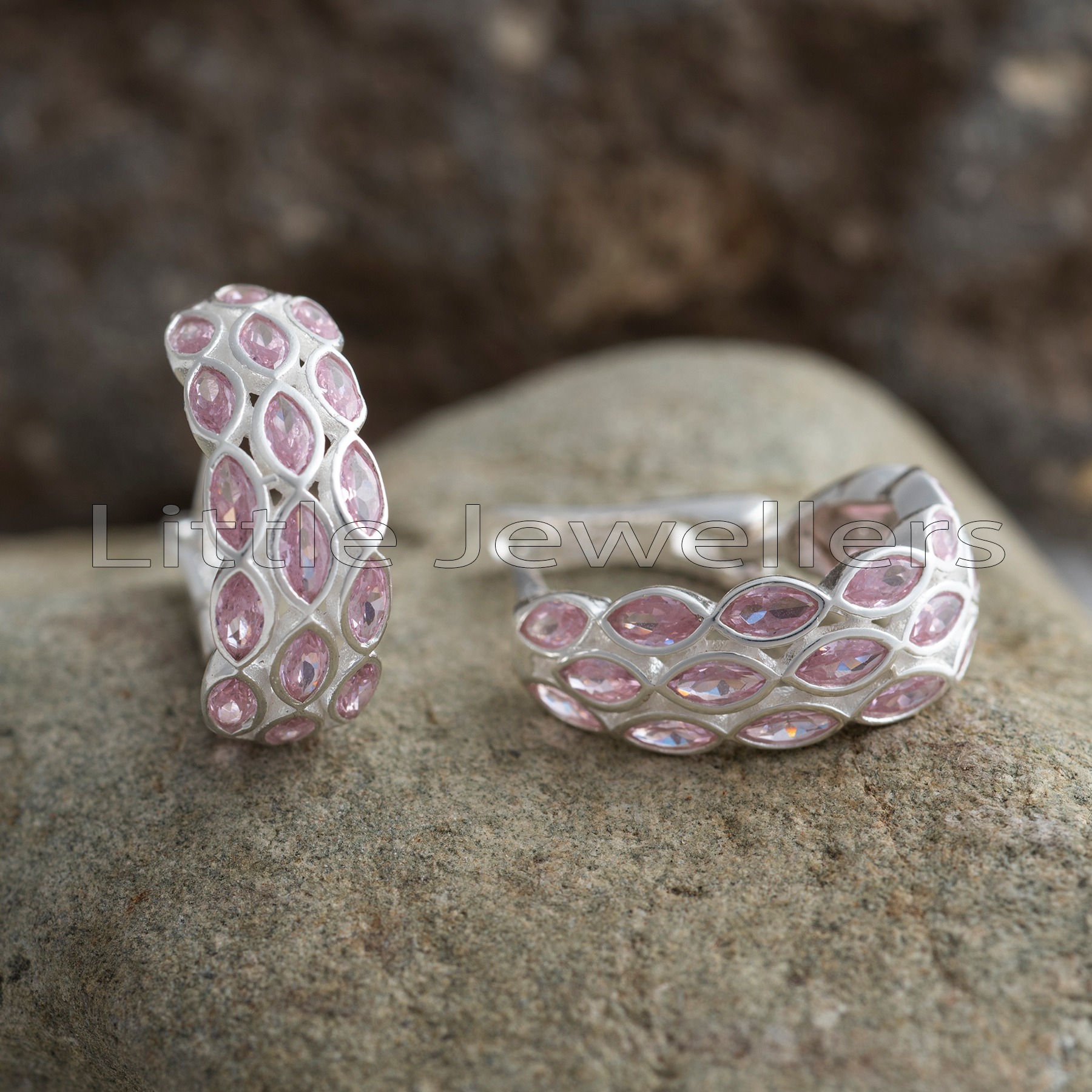 Step into sophistication with these exquisite silver earrings. Boasting a beautiful pink shimmer