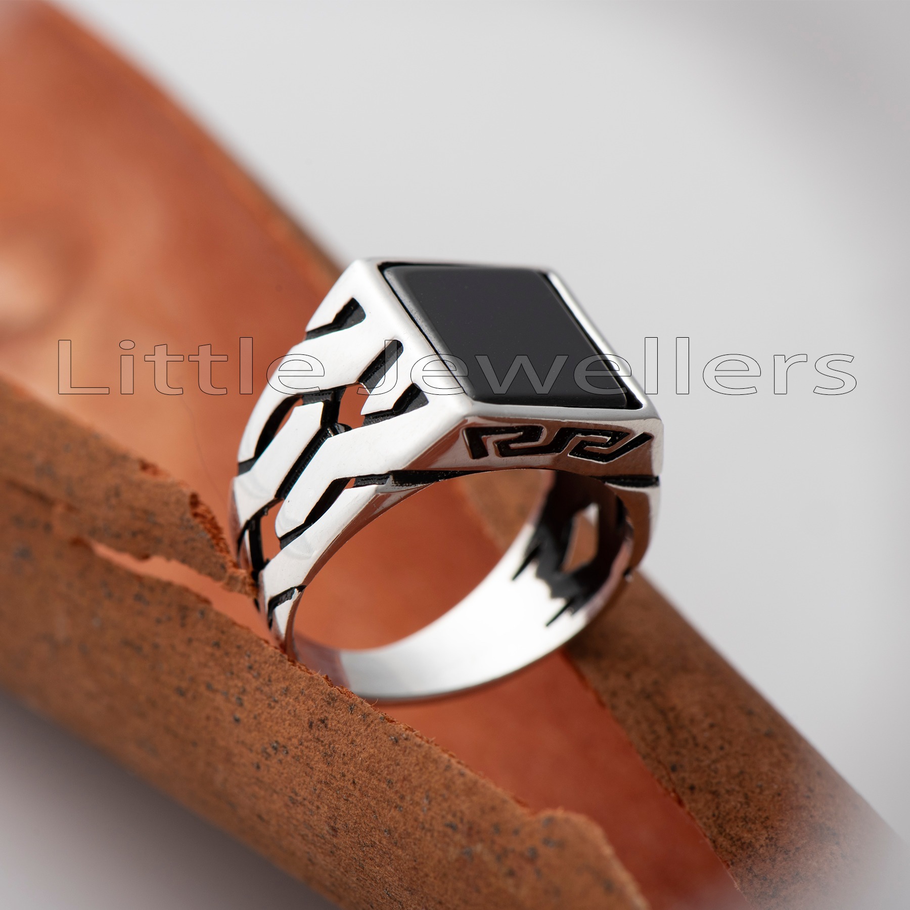 Make a statement with this silver ring for men. Featuring a black center stone and a captivating pattern