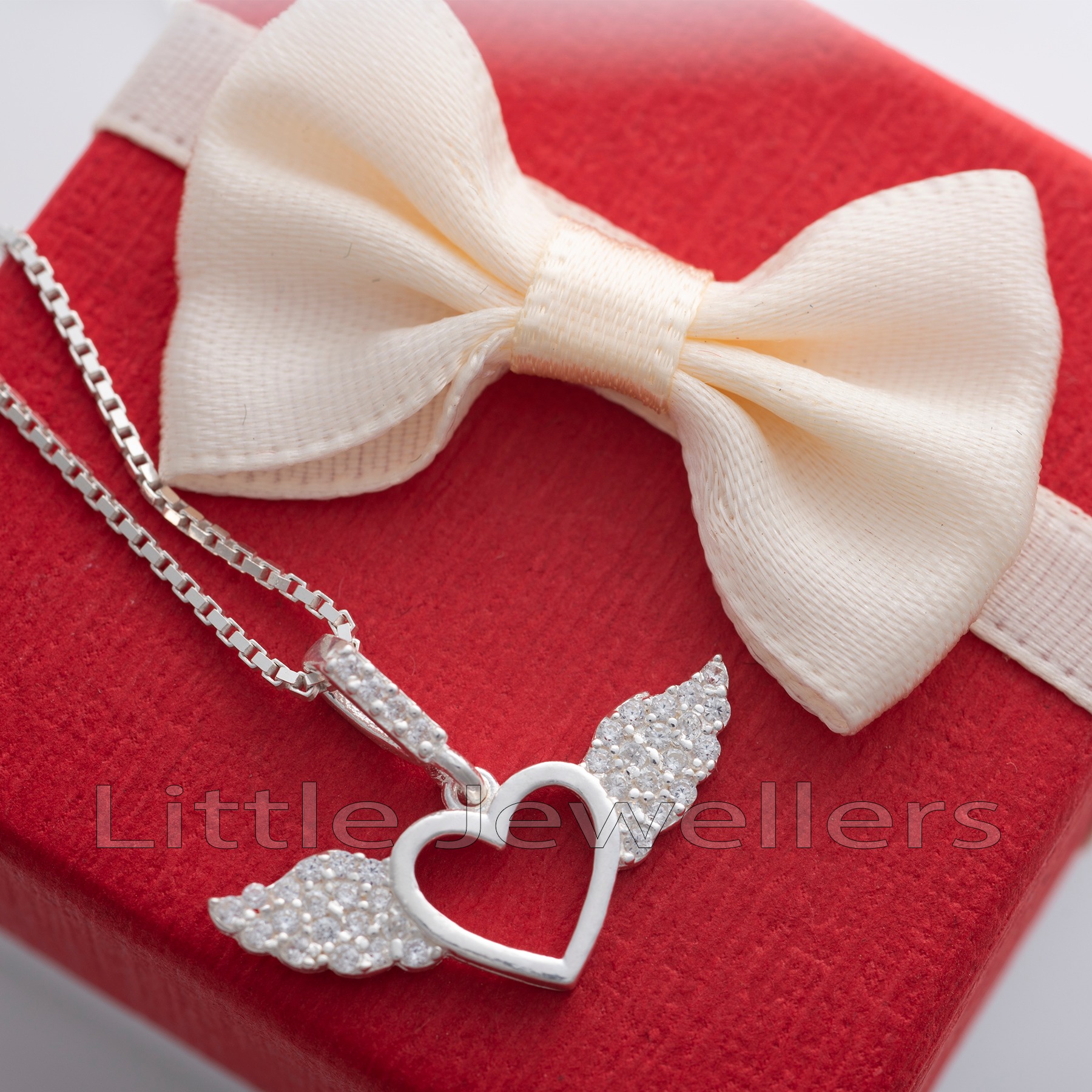 Show your love with this beautiful Sterling Silver Necklace featuring a small heart embraced by angel wings. Unique design symbolizing grace