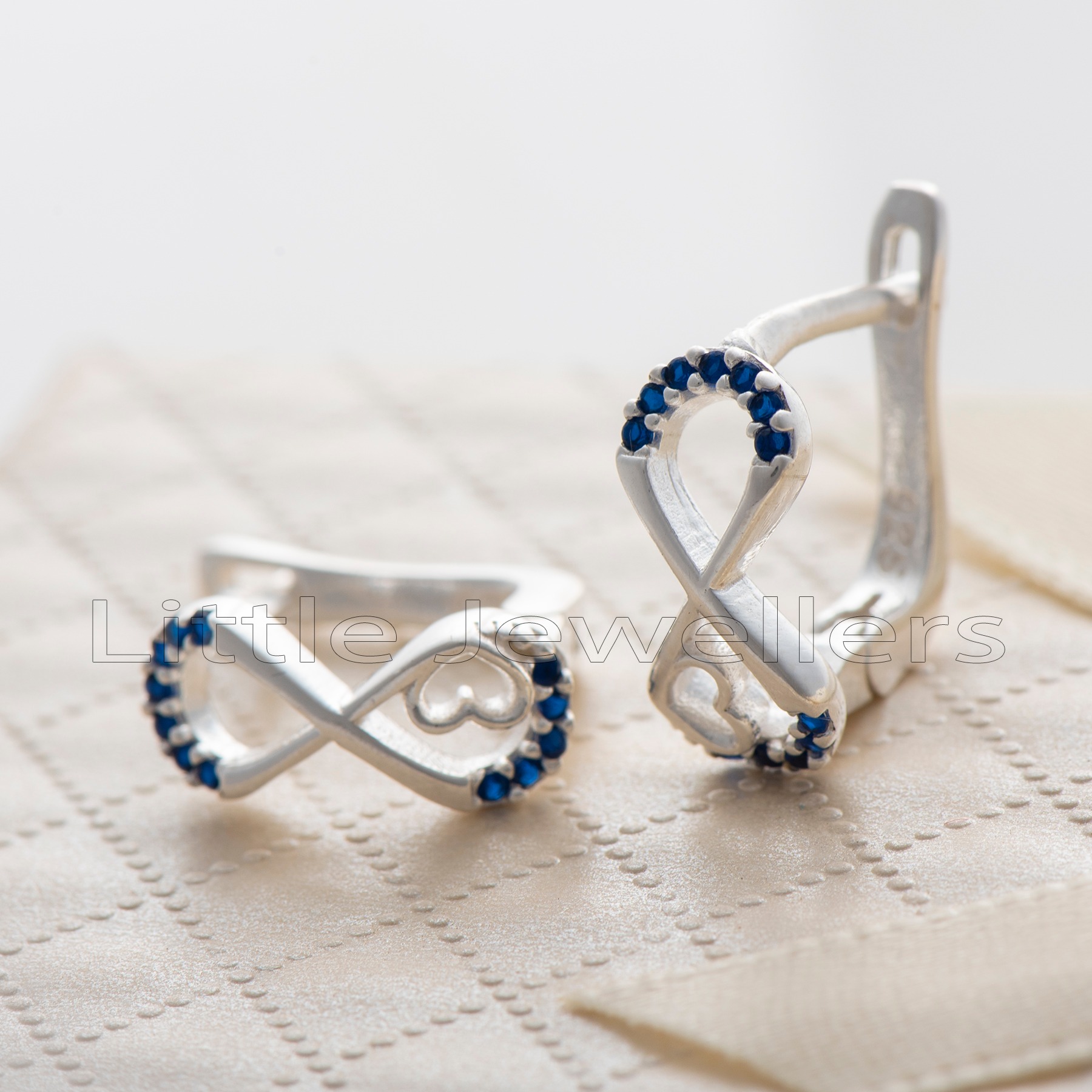 Show your love with these beautiful silver earrings. Featuring an infinity and heart design with calming blue stones