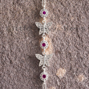 This butterfly bracelet is adorned with red and clear cz stones and is certainly a richness of beauty.