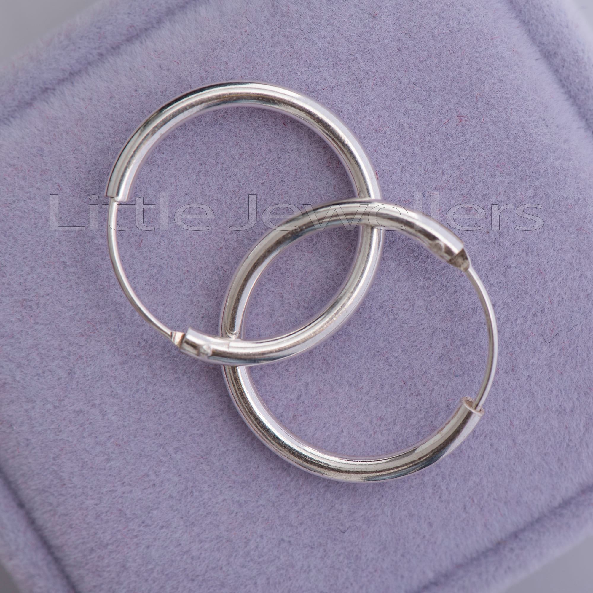 12mm hypoallergenic sterling silver hoop earrings on a purple velvet background
